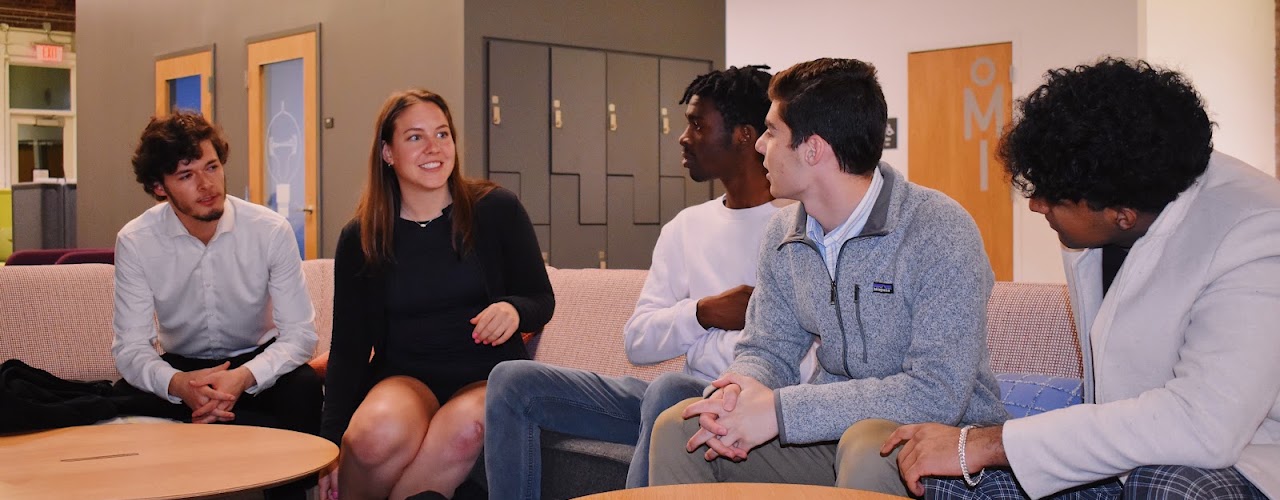 Students talking together in a campus lounge.